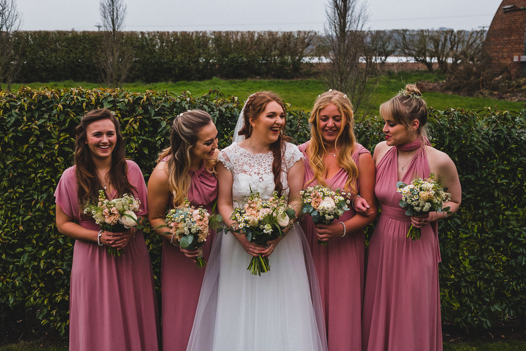 Formal photo of bridal party laughing