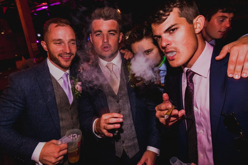 Men smoking cigars at DIY wedding.