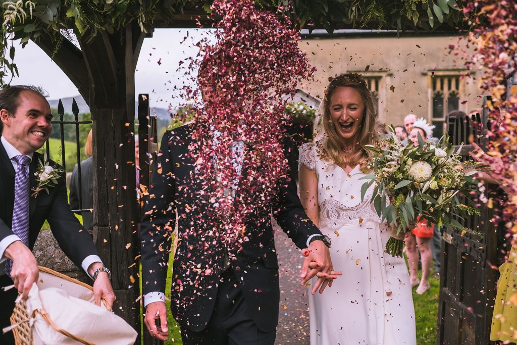 Bride and groom showered in confetti at the Inn at Whitewell wedding