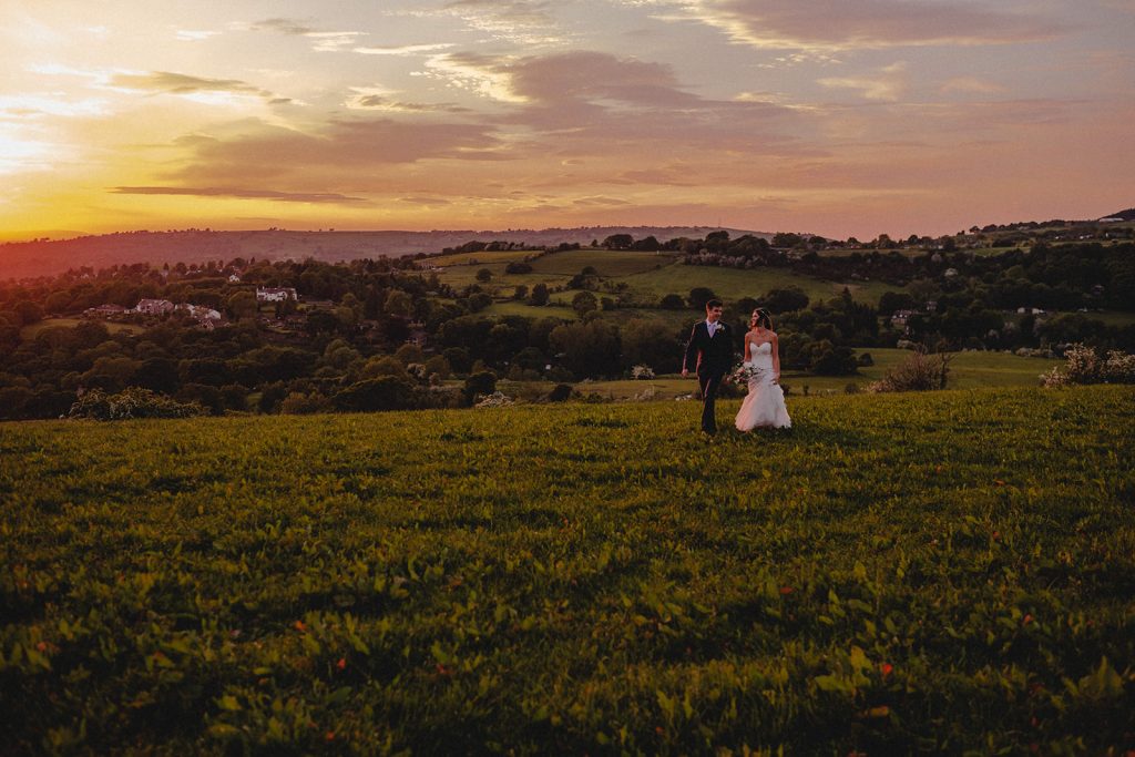 A bride and groom taking a walk after their village hall wedding ceremony.