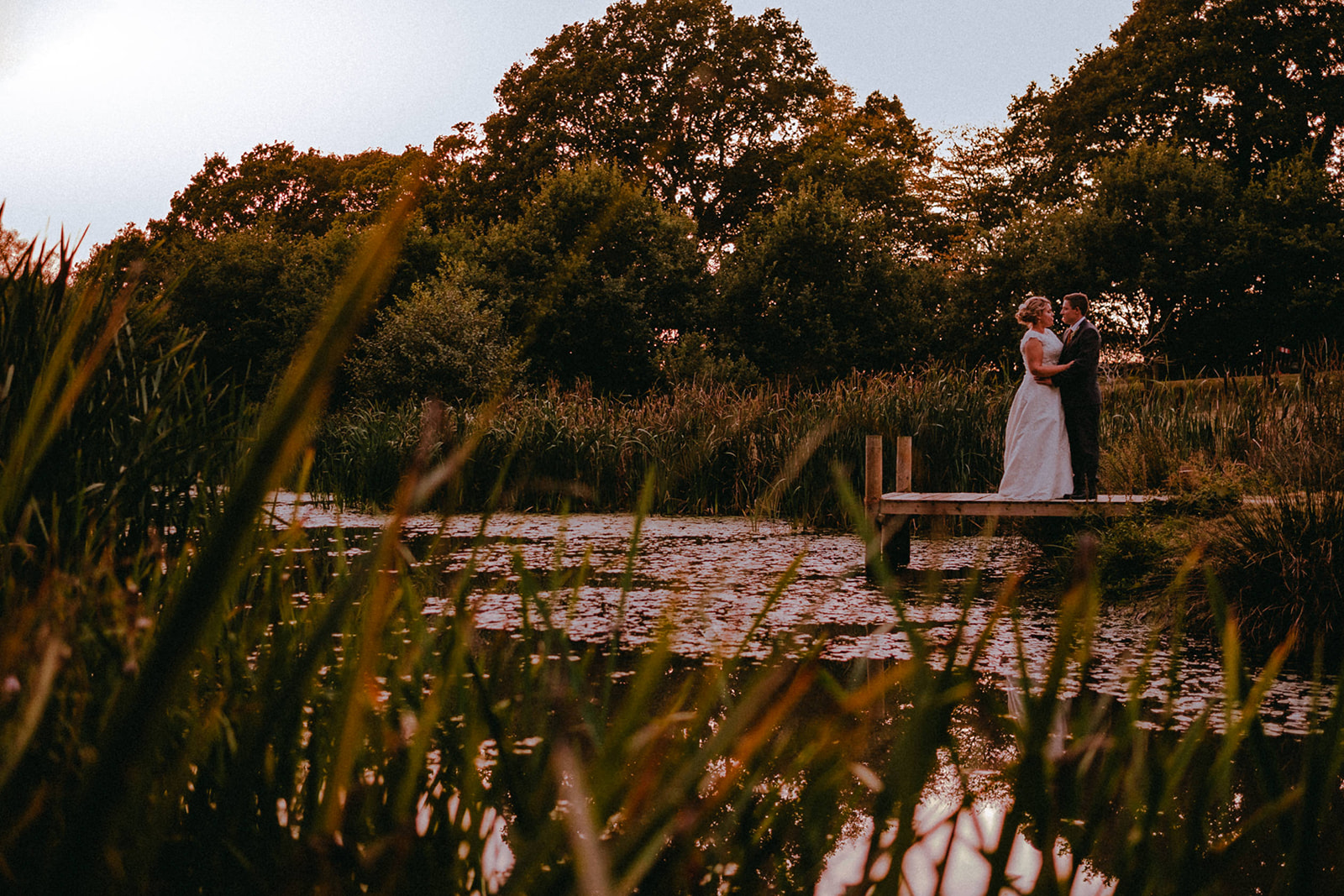 Wedding couple in their Sussex home by the pond where they got married